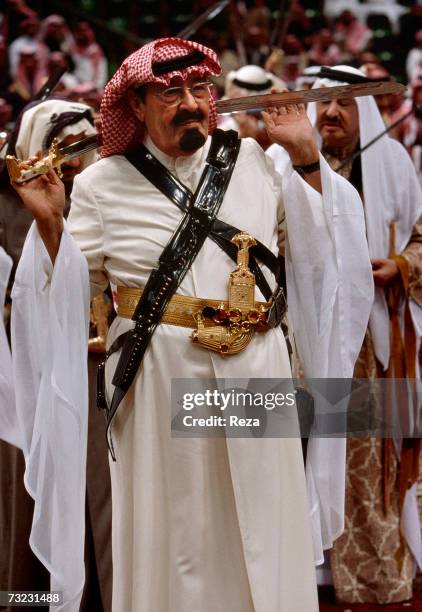 Heir Prince Abdullah bin Abdulaziz Al Saud wears traditional clothing, with a sabre, and the "khanjar", a curved Arab dagger, in preparation of...