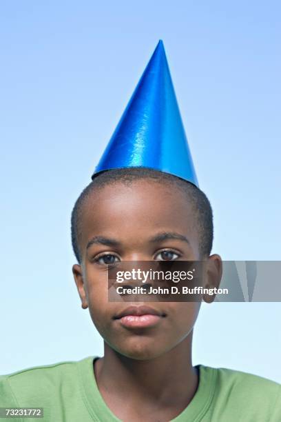 close up of african boy wearing party hat - sad birthday stock pictures, royalty-free photos & images