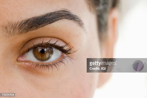 extreme close up of woman's eye - eyebrow stock pictures, royalty-free photos & images