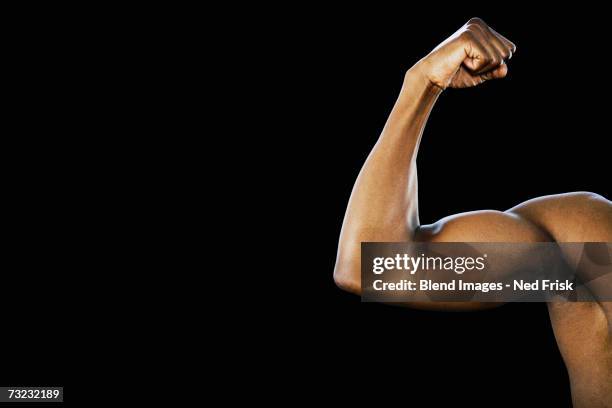 studio shot of african man flexing biceps - 二頭筋 ストックフォトと画像