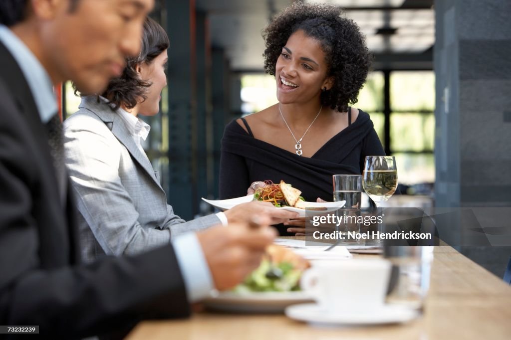 Waitress bringing food to businesswoman