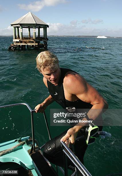 Nick Riewoldt of the Saints climbs back onto the boat after swimming with seals in Port Phillip Bay whilst on the St Kilda Saints AFL Community Camp...