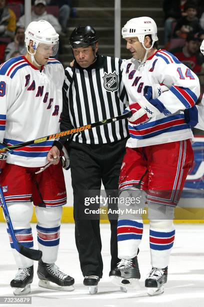 Linesman Jay Sharrers holding the skate blade of Brendan Shanahan of the New York Rangers helps Shanahan off the ice as Blair Betts looks on during...