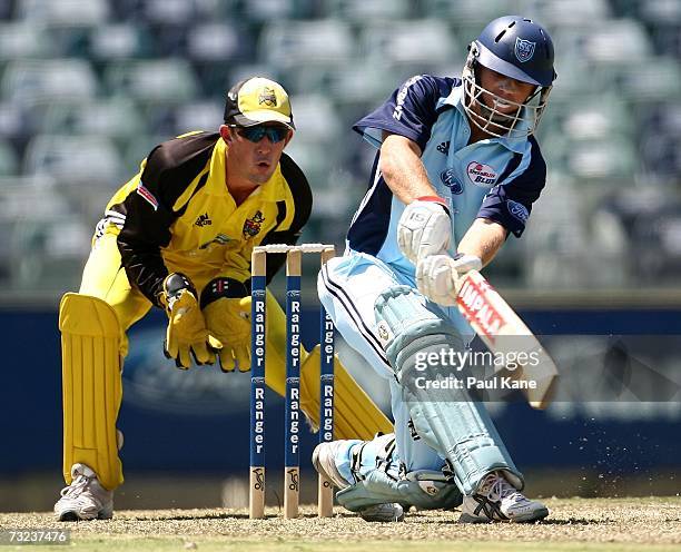 David Warner of the Blues sweeps during the Ford Ranger Cup match between the Western Australia Warriors and the New South Wales Blues at the WACA...