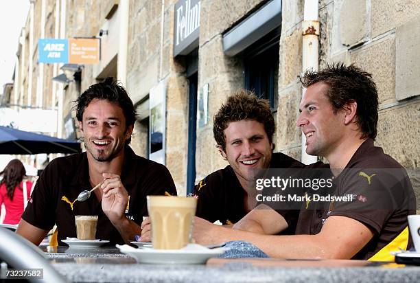 Ben Dixon, Campbell Brown and Luke Hodge of the Hawthorn Hawks relax with a coffee at Salamanca Place during the clubs AFL Community Camp on February...