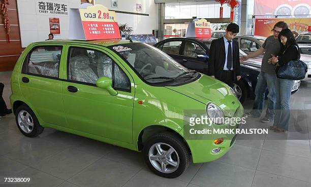 An English customer and his Chinese girlfriend view cars at a showroom for the Chinese Auto manufacturer Chery in Shanghai, 07 February 2007. China's...