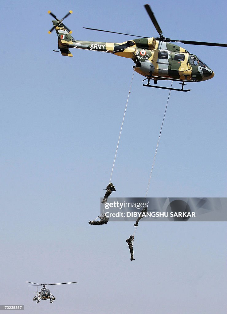 Hanging Rope Army Indian Army's Commandos hang by a rope from a helicopter during a ...