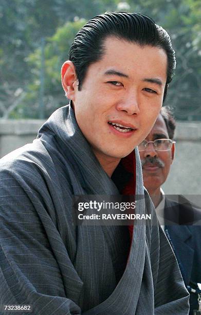 King of Bhutan Jigme Khesar Namgyel Wangchuck walks by officials upon his arrival at the Indira Gandhi International Airport in New Delhi, 07...