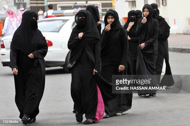 Muslim women cross a street in the holy city of Mecca in Saudi Arabia, where Palestinian Authority president Mahmud Abbas and Hamas supremo Khaled...