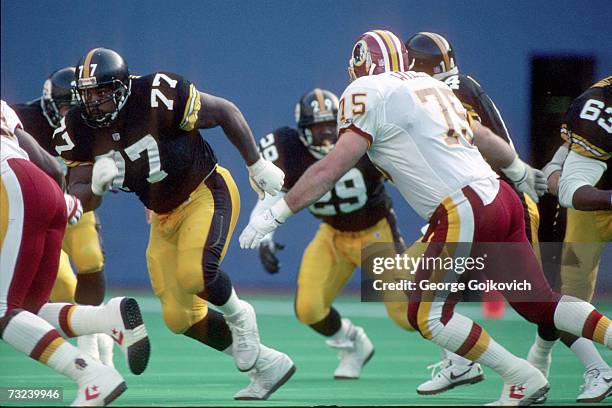 Offensive lineman Carlton Haselrig of the Pittsburgh Steelers blocks against the Washington Redskins during a game at Three Rivers Stadium on...