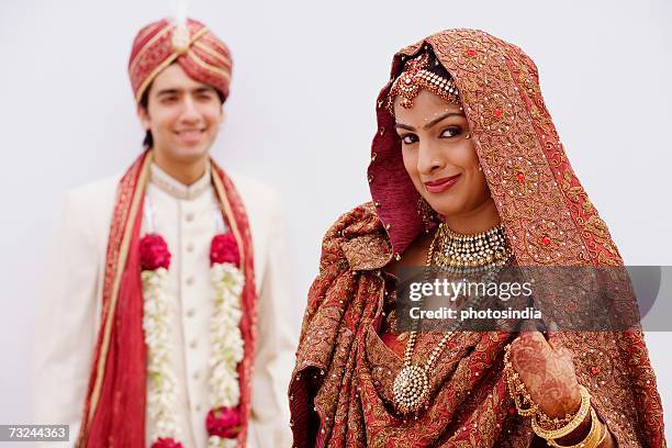 portrait of a bride smiling with her groom standing behind her - front on groom and bride stock pictures, royalty-free photos & images