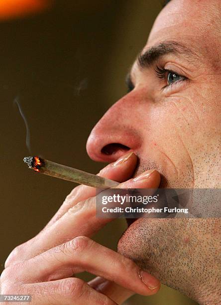 Man smokes a cigarette of marijuana in an Amsterdam cafe on February 7, 2007 in Amsterdam, Netherlands. The city council in Amsterdam has recently...