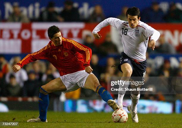 Joey Barton of England is challenged by Fernando Torres of Spain during the International Friendly match between England and Spain at Old Trafford on...