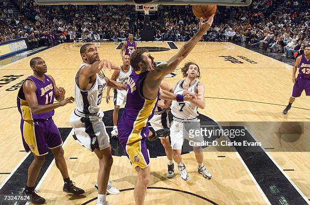 Luke Walton of the Los Angeles Lakers goes to the basket against Tim Duncan and Fabricio Oberto of the San Antonio Spurs during the game at the AT&T...