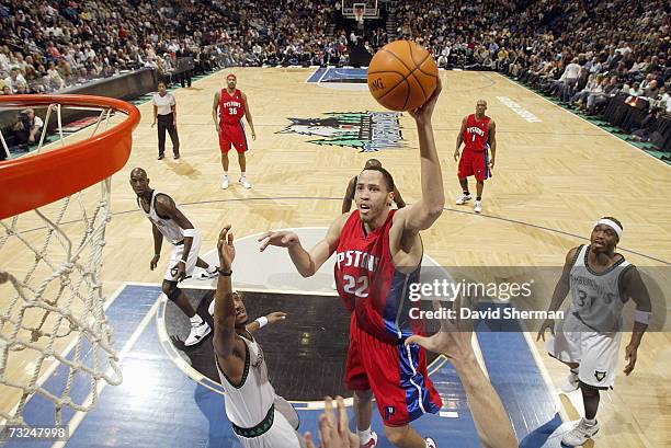 Tayshaun Prince of the Detroit Pistons goes to the basket against Bracey Wright and Ricky Davis of the Minnesota Timberwolves during the game at...