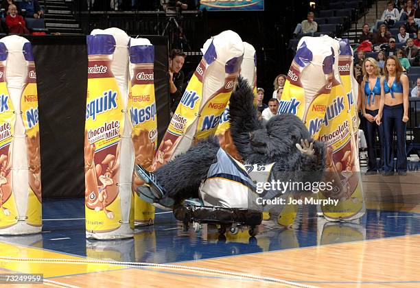 Grizz, the mascot of the Memphis Grizzlies, collides with giant chocolate milk bottles during an intermission in the game against the Sacramento...