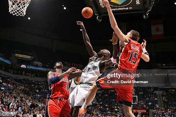 Kevin Garnett of the Minnesota Timberwolves puts up a shot against Al Harrington and Andris Biedrins of the Golden State Warriors on February 7, 2007...