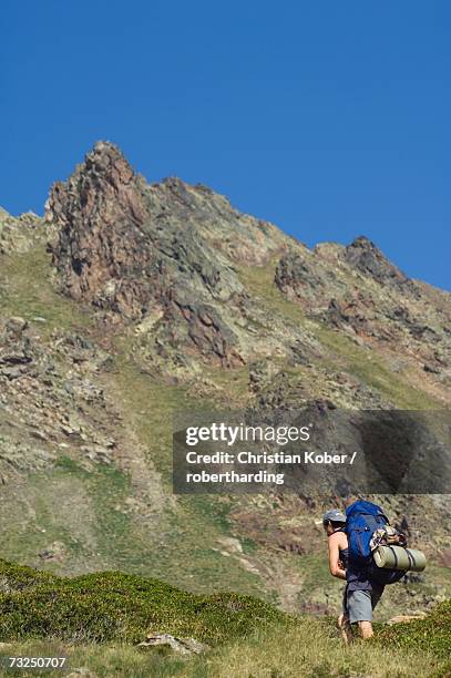 hiker on climbing trail in hiking area of pic de coma pedrosa, andorra's highest mountain, parish of la massana, andorra, pyrenees, europe - christian coma stock pictures, royalty-free photos & images