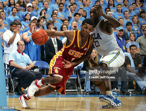 Nick Young of the USC Trojans drives to the basket past Luc Richard Mbah A Moute of the UCLA Bruins in the second half on February 7, 2007 at Pauley...