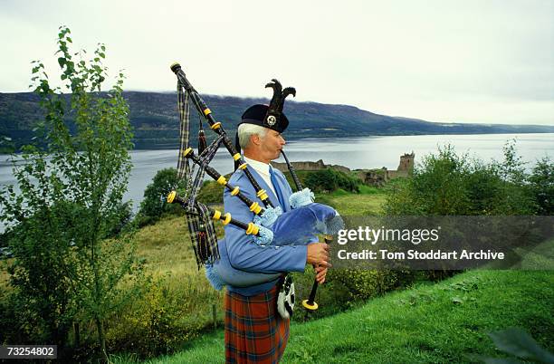 Scottish bagpiper Murdo Urquhart plays his pipes on the banks of Loch Ness, Scotland, February 1989.