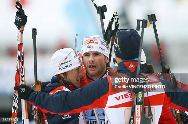 French Raphael Poiree celebrates with teammates Florence Baverel-Robert , Vincent Defrasne and Sandrine Bailly in the finish area of the Mixed 2 x 6...