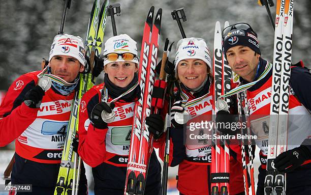Raphael Poiree, Sandrine Bailly, Florence Baverel-Robert and Vincent Defransne of France celebrate winning the silver madal of the Mixed 2 x 6 km and...
