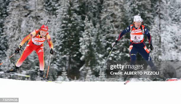 Florence Baverel-Robert of France and China Yingchao Kong competes during the Mixed 2 x 6 + 2 x 7.5 km relay race, of the Biathlon World Championship...