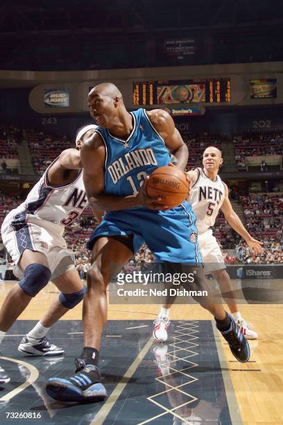 Dwight Howard of the Orlando Magic drives around Jason Collins of the New Jersey Nets on January 20, 2007 at the Continental Airlines Arena in East...