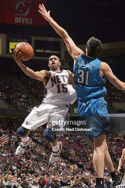 Vince Carter of the New Jersey Nets shoots against Darko Milicic of the Orlando Magic on January 20, 2007 at the Continental Airlines Arena in East...