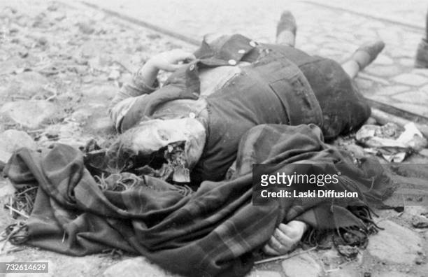 Circa 1942: The body of a woman lying in a street in Nazi-occupied Poland. A photo from an album documenting German atrocities in occupied Poland...