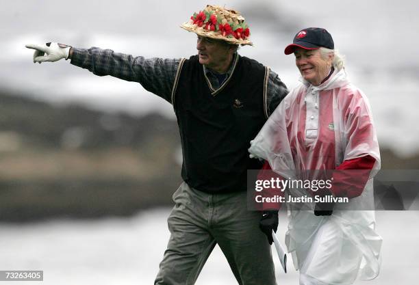 Actor Bill Murray jokes with volunteer course worker Linda Nash on the 4th tee of Spyglass Hill Golf Course during the first round of the AT&T Pebble...