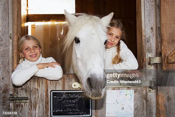 two girls with horse in stable, portrait - door name plate stock pictures, royalty-free photos & images