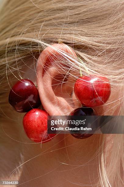 girl wearing cherries on ear, close-up - orelha humana - fotografias e filmes do acervo