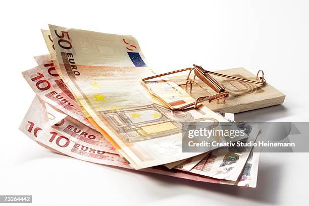 euro notes in mousetrap, close-up - mousetrap stock pictures, royalty-free photos & images