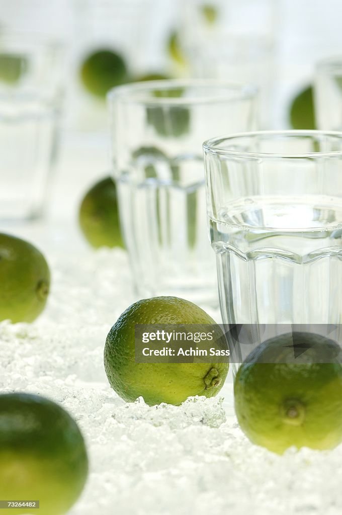 Lime fruits and water glass on crushed ice