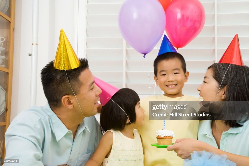 Young Asian boy celebrating birthday with family