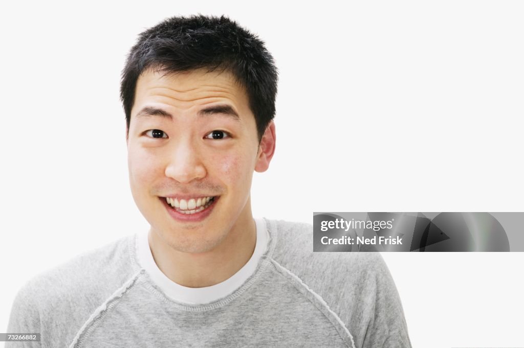 Studio shot of Asian man smiling