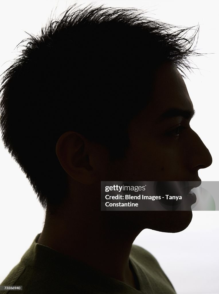 Studio shot profile silhouette of young man