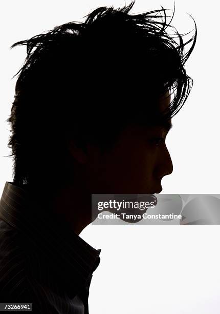 studio shot profile silhouette of young man - man silhouette profile stock pictures, royalty-free photos & images