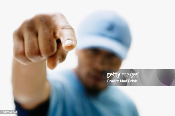 close up of african man pointing - finger pointing stock-fotos und bilder