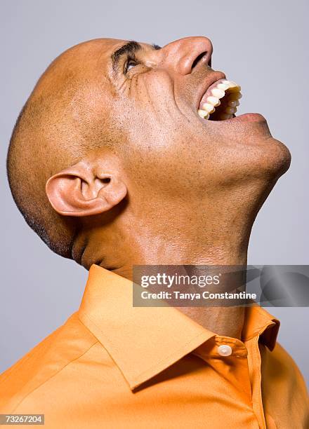 studio shot of man laughing and looking up - funny black people faces stock pictures, royalty-free photos & images