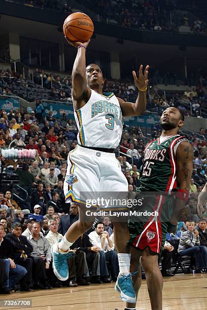 Chris Paul of the New Orleans/Oklahoma City Hornets shoots the ball against Maurice Williams of the Milwaukee Bucks during an NBA game on February 8,...