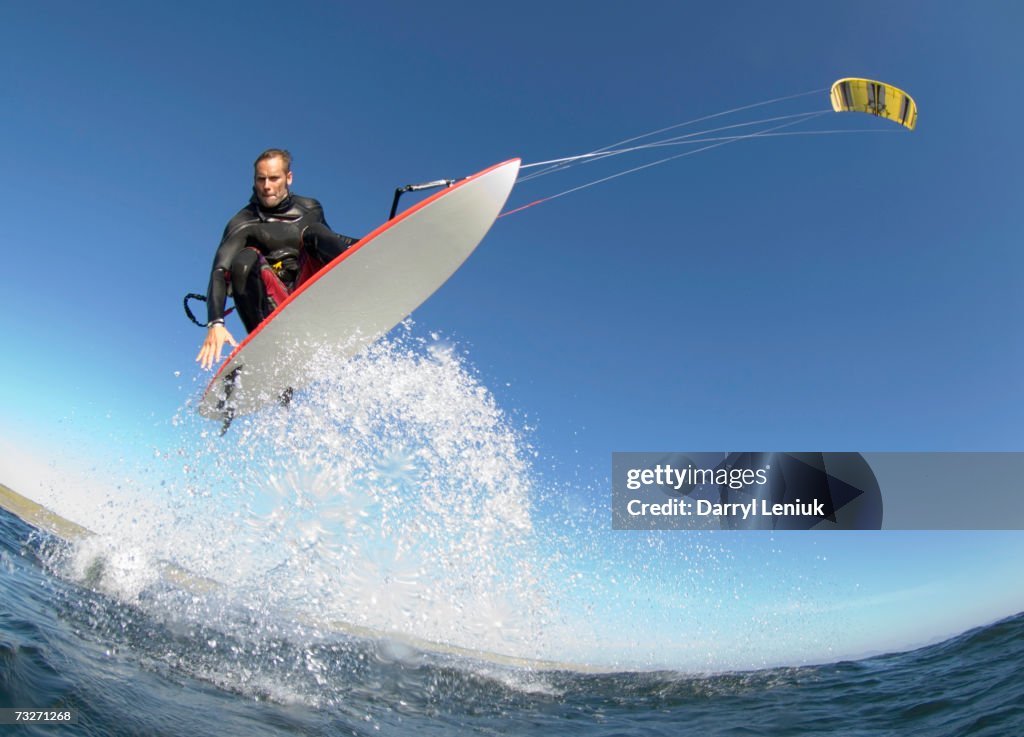 Man kiteboarding, low angle view