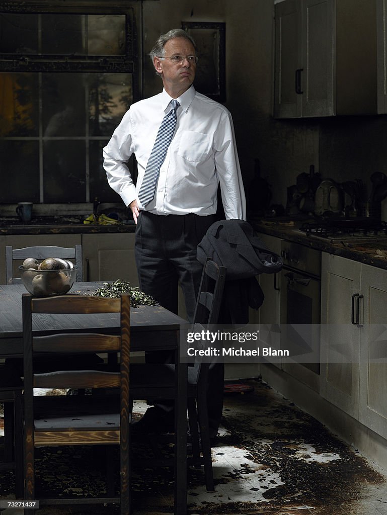 Man looking at kitchen damaged in fire