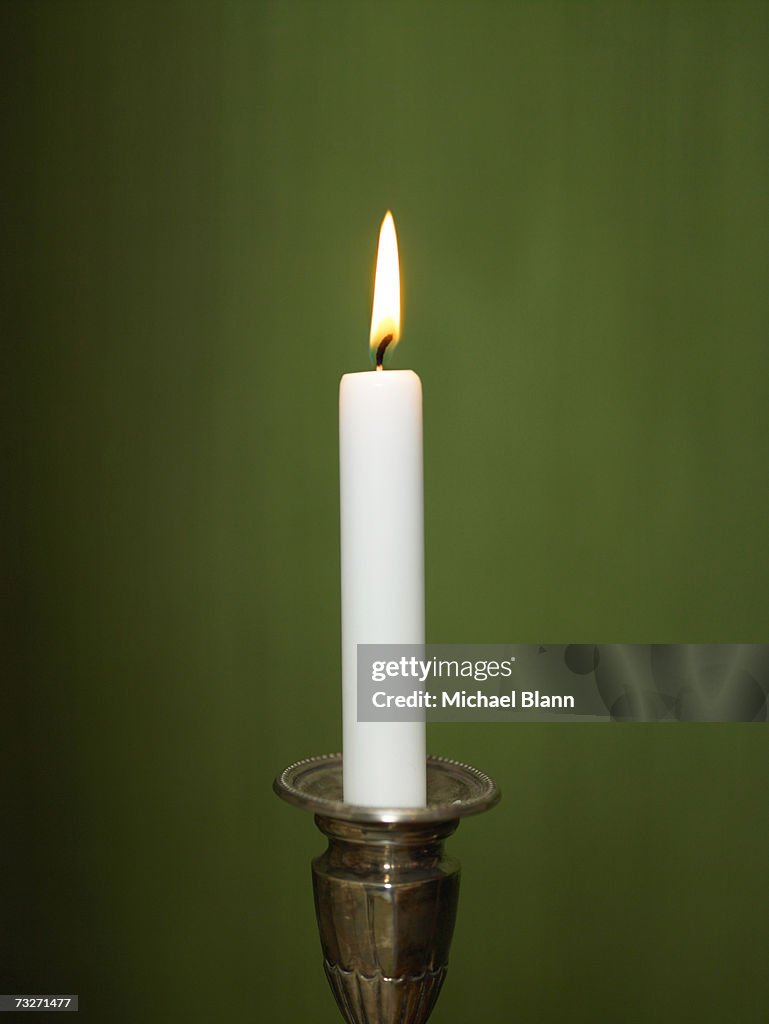 Candle lit in candle holder