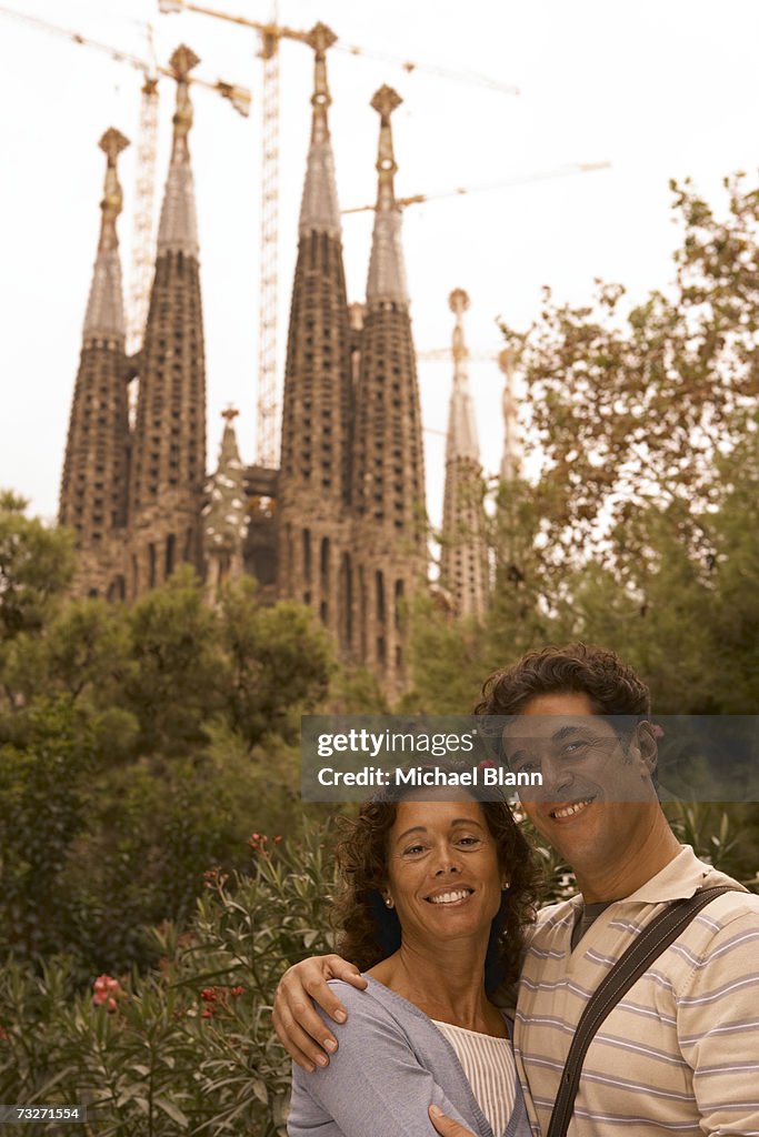 Couple in front of Sagrada Familia Cathedral, Barcelona, Spain