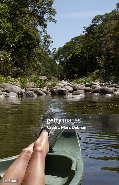 young woman relaxing in boat on river, low section - daintree australia stock pictures, royalty-free photos & images