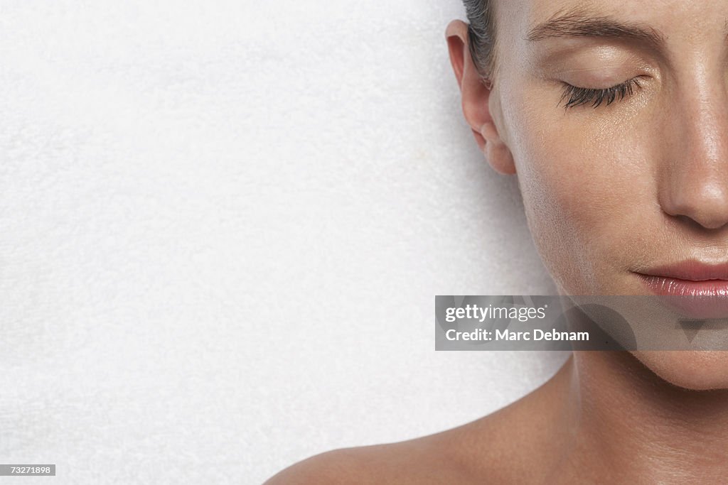 Young woman with eyes closed, smiling, close-up