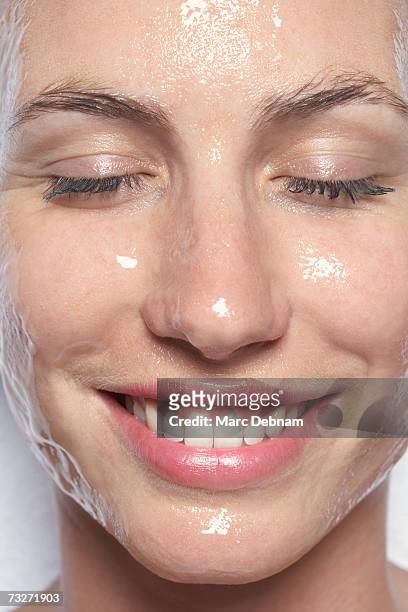 young woman with eyes closed, smiling, close-up - 汗 ストックフォトと画像