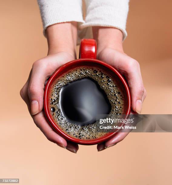 "woman holding coffee cup, close-up, overhead view" - red mug stock pictures, royalty-free photos & images